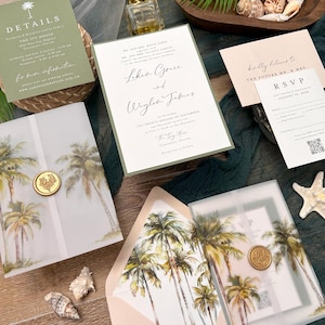 May include: Wedding invitation suite with a tropical theme. The invitations are printed on white cardstock with green and gold accents. The RSVP card is printed on white cardstock with a gold border. The envelopes are lined with a tropical palm tree design.