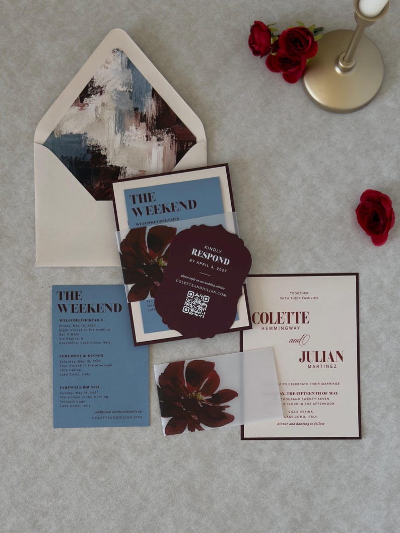 Blush floral wedding invitation paired with a burgundy scalloped RSVP card and dusty blue details card, featuring a romantic deep burgundy floral design and elegant vintage-inspired typography.