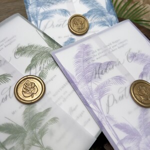 May include: Wedding invitations with a tropical palm tree design in blue, green, and purple. Each invitation is sealed with a gold wax stamp. The invitations are on a white background.
