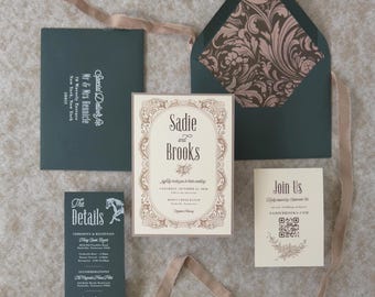 May include: A wedding invitation suite featuring a cream-coloured main card with ornate brown borders, a dark green envelope with a patterned liner, a details card, and a response card with a QR code, all accented by a long, light brown silk ribbon.