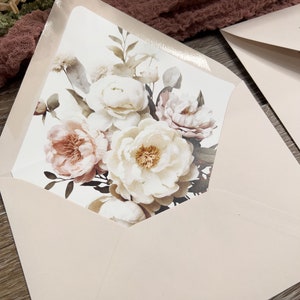 Peach and ivory floral envelope liner with elegant botanical wedding stationery.
