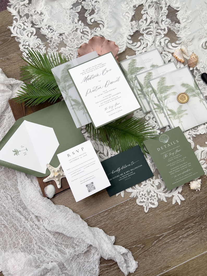 May include: Wedding invitation suite featuring a main invitation with names and event details, RSVP card, details card, and envelopes. The design includes palm tree illustrations and a wax seal. Colors include white, green, and dark green.