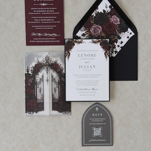 Lenore Gothic romance invitation with a white invitation layered over Ebony cardstock, dark rose printed vellum jacket, black mailing envelope with floral liner, and coordinating burgundy and gray inserts.