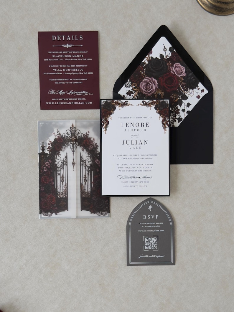 Lenore Gothic romance invitation with a white invitation layered over Ebony cardstock, dark rose printed vellum jacket, black mailing envelope with floral liner, and coordinating burgundy and gray inserts.