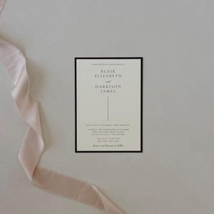 Brown and ivory Blair wedding invitation suite with monogram vellum, arch RSVP card and floral envelope liner styled in a warm romantic neutral palette.