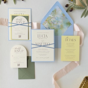 Blue, yellow and ivory Lucia wedding stationery featuring a layered invitation, arch RSVP card, butter yellow details card and soft watercolor floral envelope liner.
