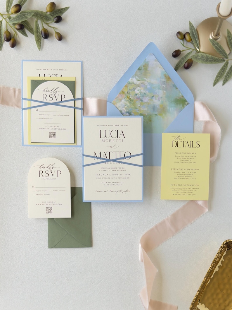 Blue, yellow and ivory Lucia wedding stationery featuring a layered invitation, arch RSVP card, butter yellow details card and soft watercolor floral envelope liner.