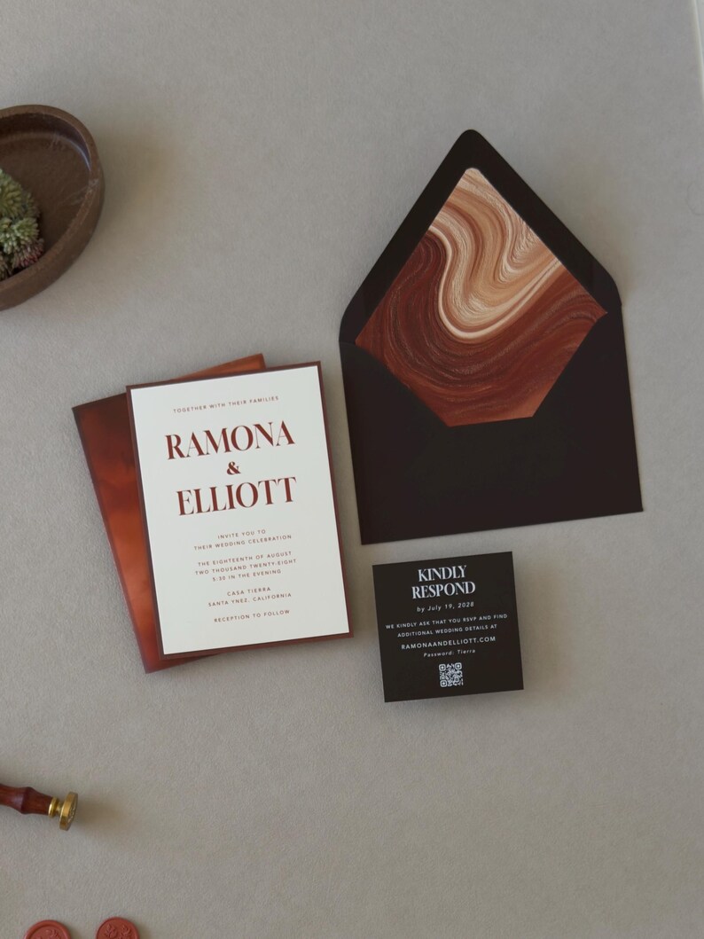 Modern rust and brown Ramona wedding invitation suite featuring a layered ivory invitation, dark chocolate RSVP card and artistic terracotta stationery details.