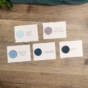 May include: Five rectangular off-white cards with deckled edges, each featuring a circular wax seal with a floral design. The cards are labeled Baby Blue, Dusty Lavender, Dusty Blue, Sapphire, and Navy, corresponding to the color of each wax seal.