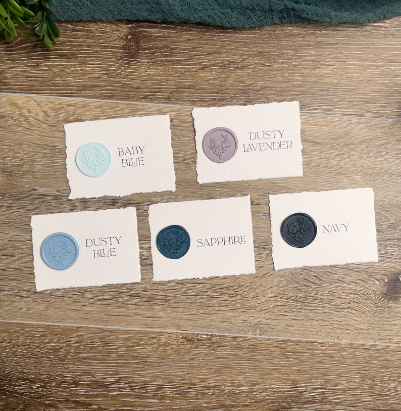 May include: Five rectangular off-white cards with deckled edges, each featuring a circular wax seal with a floral design. The cards are labeled Baby Blue, Dusty Lavender, Dusty Blue, Sapphire, and Navy, corresponding to the color of each wax seal.