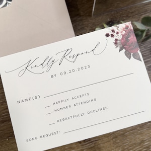 Wedding RSVP card with burgundy floral detail and elegant coordinating stationery.
