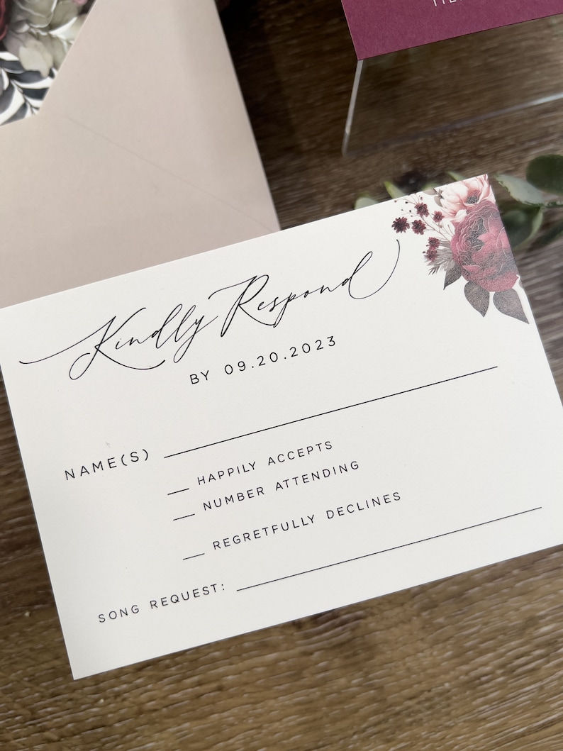 Wedding RSVP card with burgundy floral detail and elegant coordinating stationery.