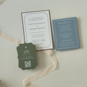 Ivory country wedding invitation with dusty blue details card and dark green scalloped RSVP card, styled with soft cream ribbon for a romantic estate or countryside wedding.
