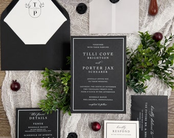 May include: Black and white wedding invitation suite with a simple design. The invitation features the couple's names, wedding date, and venue. The RSVP card includes a response section for guests to indicate their attendance.