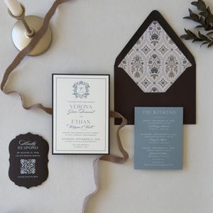 Styled Verona dusty blue wedding invitation suite with coordinating details card and wax seal