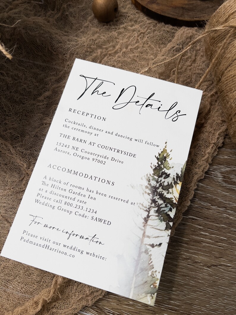 May include: A white wedding invitation card with black text. The card features a watercolour illustration of a snowy forest scene with pine trees. The text reads "The Details", "Reception", "Cocktails, dinner and dancing will follow the ceremony at", "THE BARN AT COUNTRYSIDE", "15243 NE Countryside Drive", "Aurora, Oregon 97002", "ACCOMMODATIONS", "A block of rooms has been reserved at", "The Hilton Garden Inn", "at a discounted rate", "Please call 800.233.1234", "Wedding Group Code: SAWED", "For more information", "Please visit our wedding website: PadmaandHarrison.co".