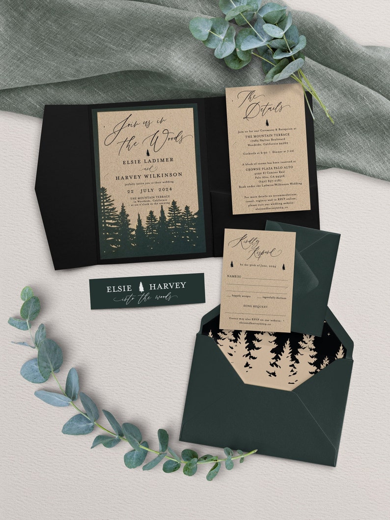May include: A wedding invitation suite with a rustic woodland theme. The invitation features a forest silhouette with the text "Join us in the Woods" and the couple's names, Elsie and Harvey. The details card includes the date, time, and location of the wedding ceremony and reception. The RSVP card features a forest silhouette and the text "Kindly Respond".