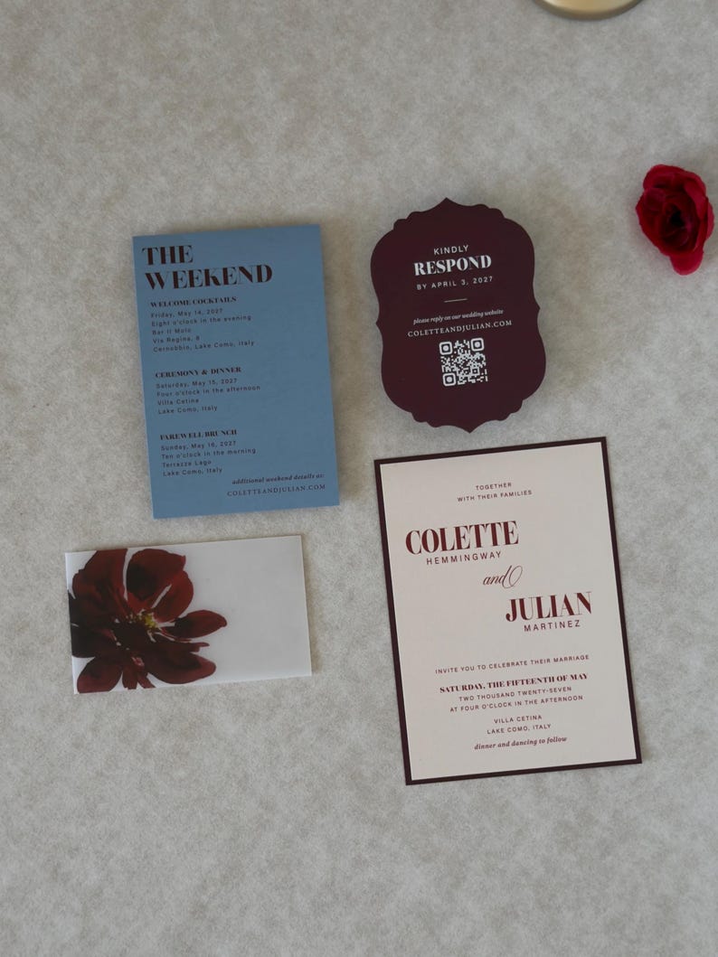 Elegant floral wedding stationery in burgundy, dusty blue and ivory, featuring an ivory invitation with deep burgundy floral artwork, blue details card, scalloped burgundy RSVP and floral envelope liner.