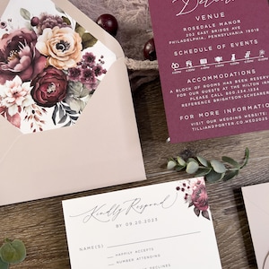 Burgundy and mauve wedding stationery with floral envelope liner and coordinating invitation pieces.