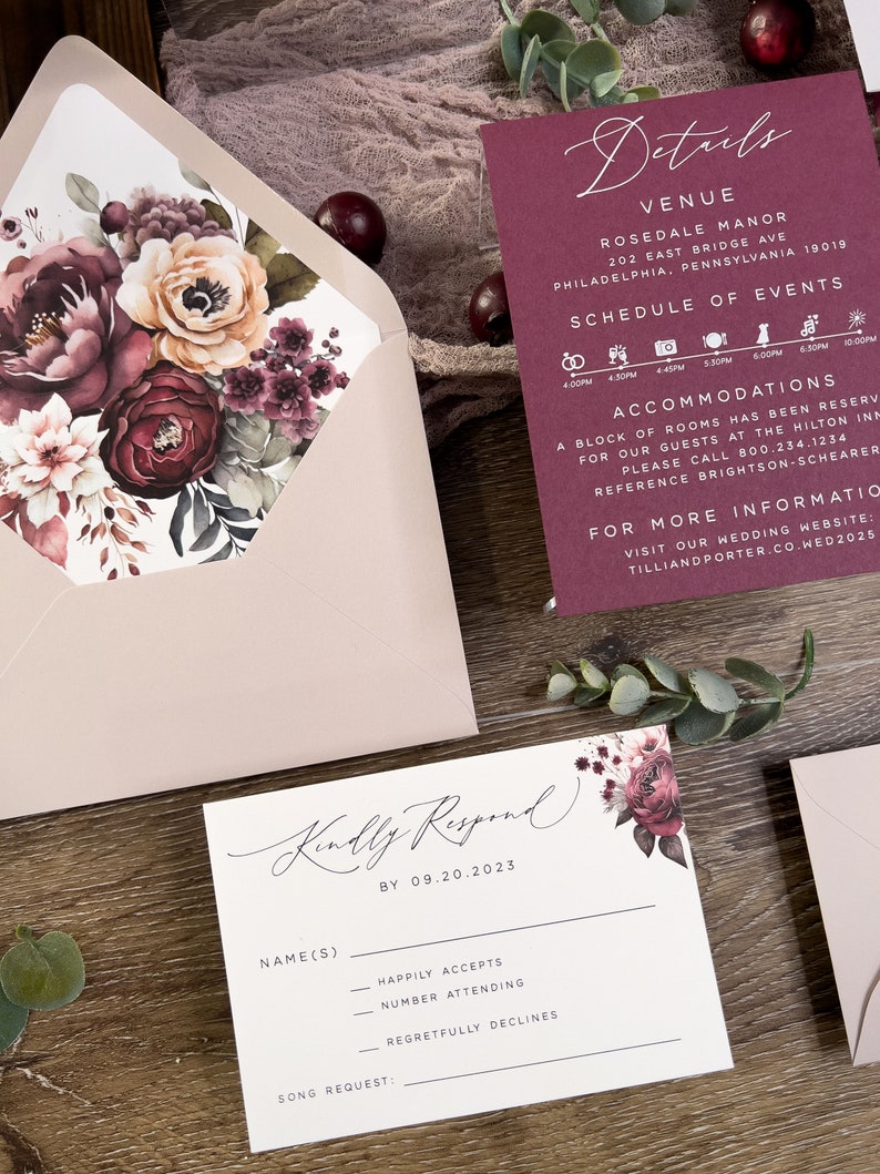 Burgundy and mauve wedding stationery with floral envelope liner and coordinating invitation pieces.