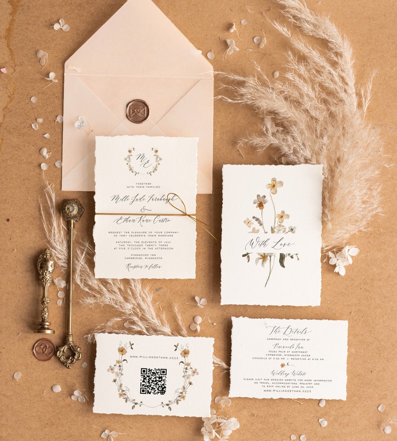 May include: Wedding invitation suite with a floral theme. The invitation features a wreath of flowers with the couple's names and wedding date. The RSVP card has a floral design and the text "The Details".