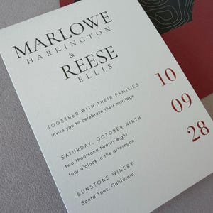 May include: A white wedding invitation card with black serif text reading MARLOWE HARRINGTON & REESE ELLIS, followed by event details for October ninth, two thousand twenty eight at Sunstone Winery. The date 10 09 28 is printed in red on the right.