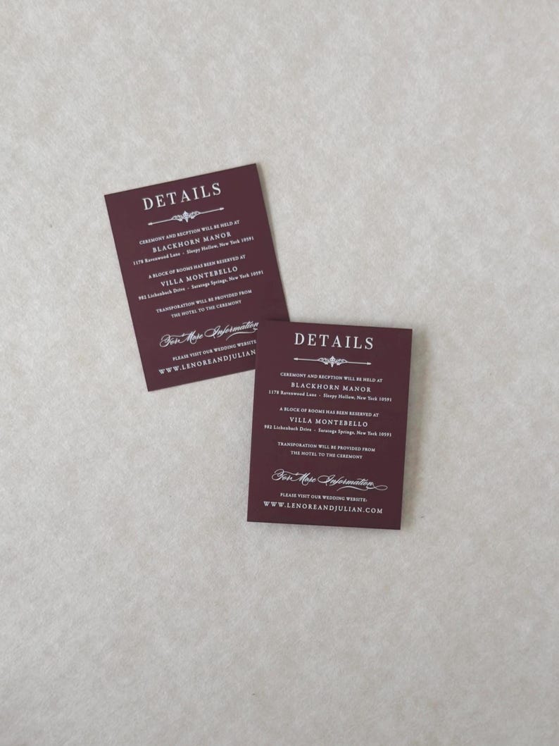 Two coordinating Claret burgundy wedding details cards featuring white ink-style typography, displaying reception and accommodation information for the Lenore Gothic floral wedding invitation suite.