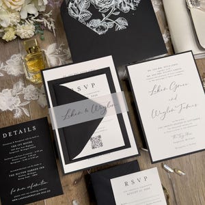 May include: Black and white wedding invitation suite with a floral design. The invitation includes details about the ceremony and reception, RSVP information, and a QR code. The text on the invitation reads "Laken & Waylon" and "The Twenty Second of September".