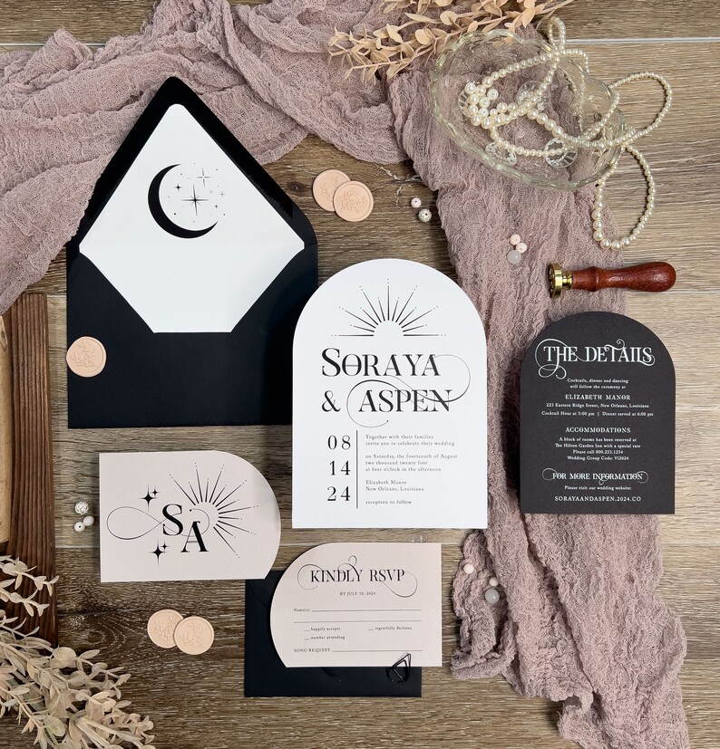 May include: Wedding invitation suite with a modern, minimalist design. The invitation features a black and white arch with the names "Soraya & Aspen" and the date "08.14.24". The RSVP card is black and white with the text "Kindly RSVP". The details card is black with white text and includes the venue, time, and other important information.