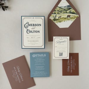 Emerson wedding invitation assembly video showing the dusty blue details card and coordinating western-inspired stationery pieces.