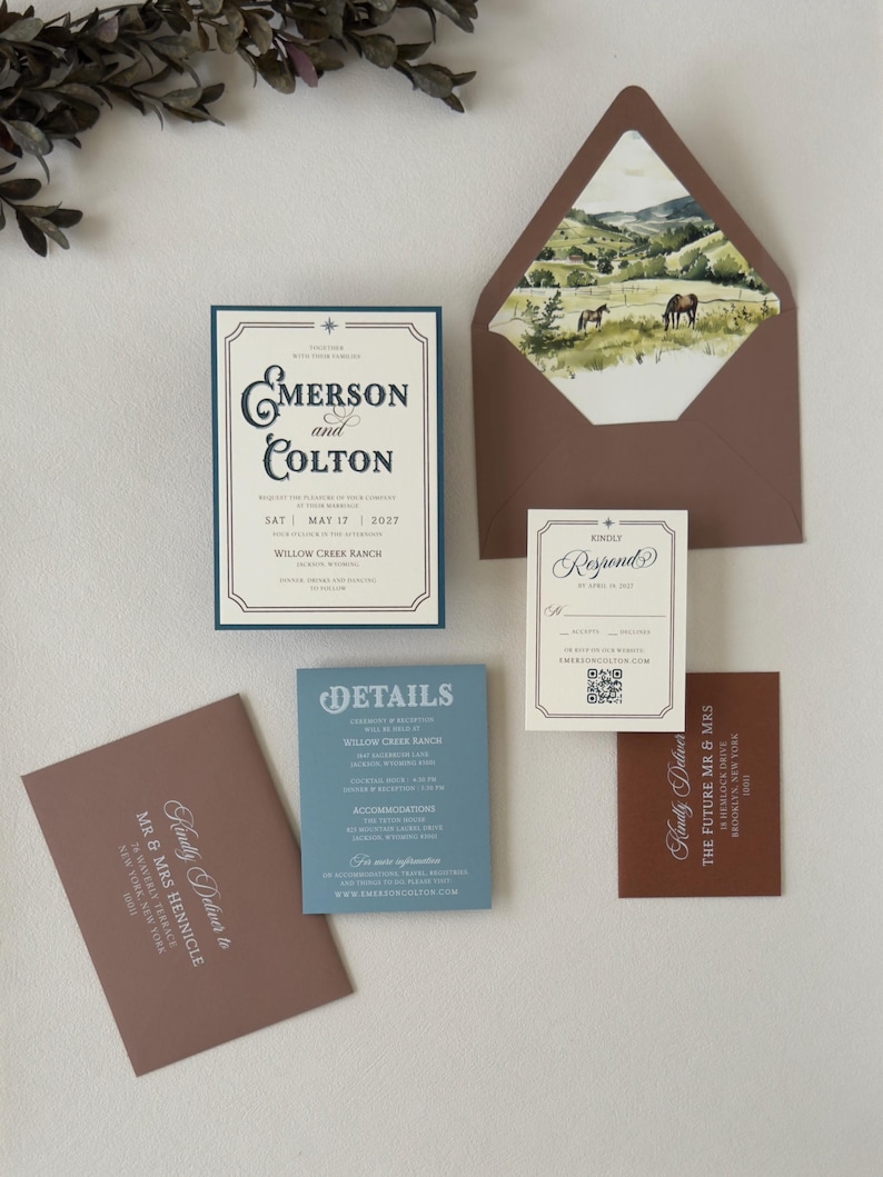 Emerson wedding invitation assembly video showing the dusty blue details card and coordinating western-inspired stationery pieces.