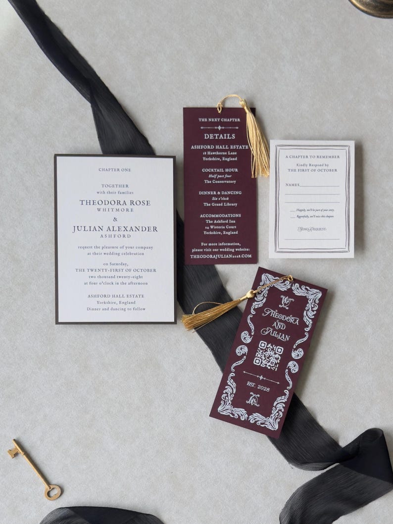 Theodora wedding invitation suite featuring elegant ivory invitation typography, burgundy bookmark with gold tassel, antique-style decorative cards, and coordinating dark brown stationery against a neutral background.