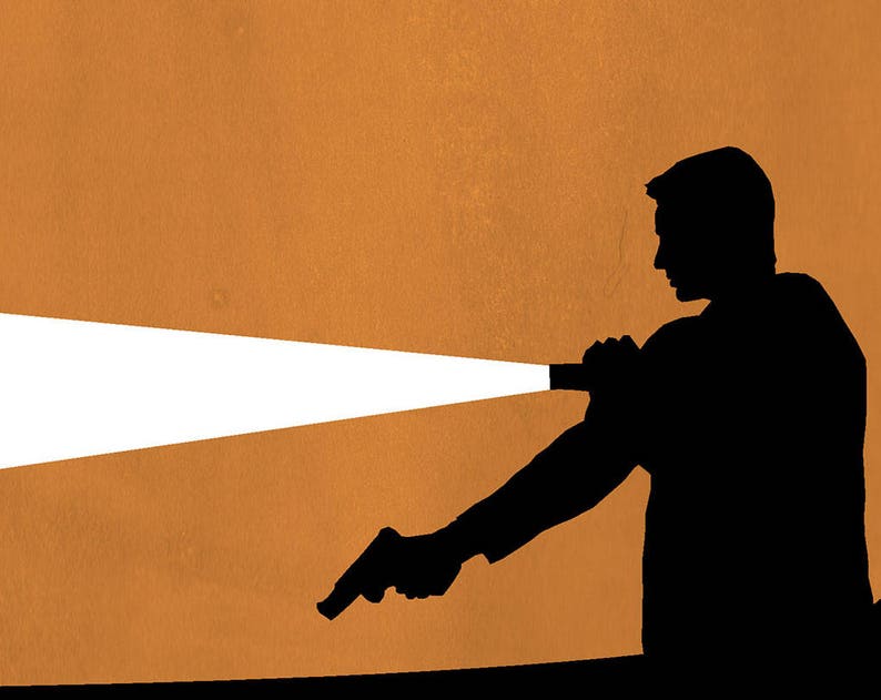 May include: Silhouette of a person holding a flashlight in their right hand, shining a beam of light to the left. The person is wearing a dark shirt and is standing against a brown background.