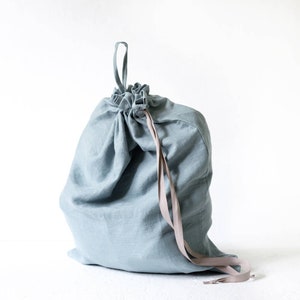 Hanging laundry hamper made of stone washed linen in marine color