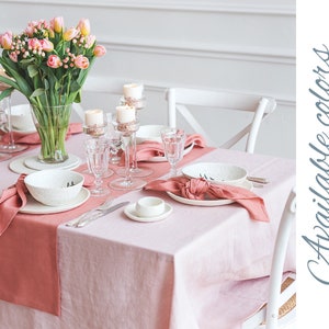 May include: A pink linen tablecloth with a pink linen napkin and a white ceramic bowl on a table setting. The table is decorated with a bouquet of pink tulips and candles. The image includes the text "Available colors".