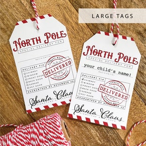 May include: Two white gift tags with red and white striped trim. The tags are labeled "North Pole Special Delivery For" and have a checklist of delivery options, including chimney, window, front door, back door, garage, and pet door. Each tag has a red "Delivered" stamp with a snowflake and the words "Express Mail". The tags are guaranteed by December 25th by Santa Claus.