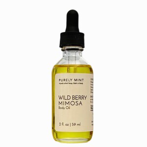 Wild Berry Mimosa body oil in glass bottle with white label and black dropper top, white background.