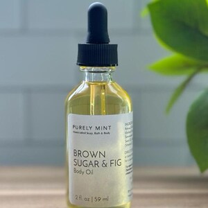 Organic Vegan Body Oil: Nut-Free, Sensitive Skin, Natural Moisturizer in a clear glass bottle with a black lid filled with Brown Sugar & Fig body oil.