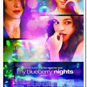 May include: Movie poster for the film "My Blueberry Nights" featuring actors Norah Jones, Jude Law, David Strathairn, Rachel Weisz, and Natalie Portman. The poster has a colorful, abstract background with a blurred city skyline and bright lights.