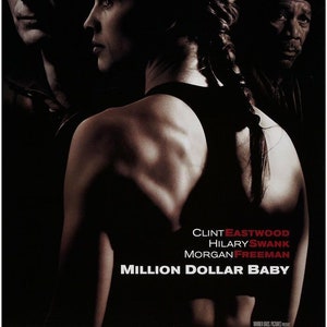May include: Movie poster for the film "Million Dollar Baby" starring Clint Eastwood, Hilary Swank, and Morgan Freeman. The poster features a close-up of Hilary Swank's back as she wears a black tank top.