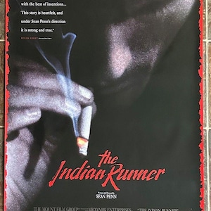 May include: Movie poster for the film "The Indian Runner" directed by Sean Penn. The poster features a close-up of a man's face with a cigarette in his hand. The title of the film is written in red and white lettering.