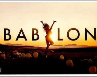 May include: A poster for the movie "Babylon" featuring a silhouette of a woman dancing against a sunset backdrop. The title "Babylon" is written in large, bold letters.