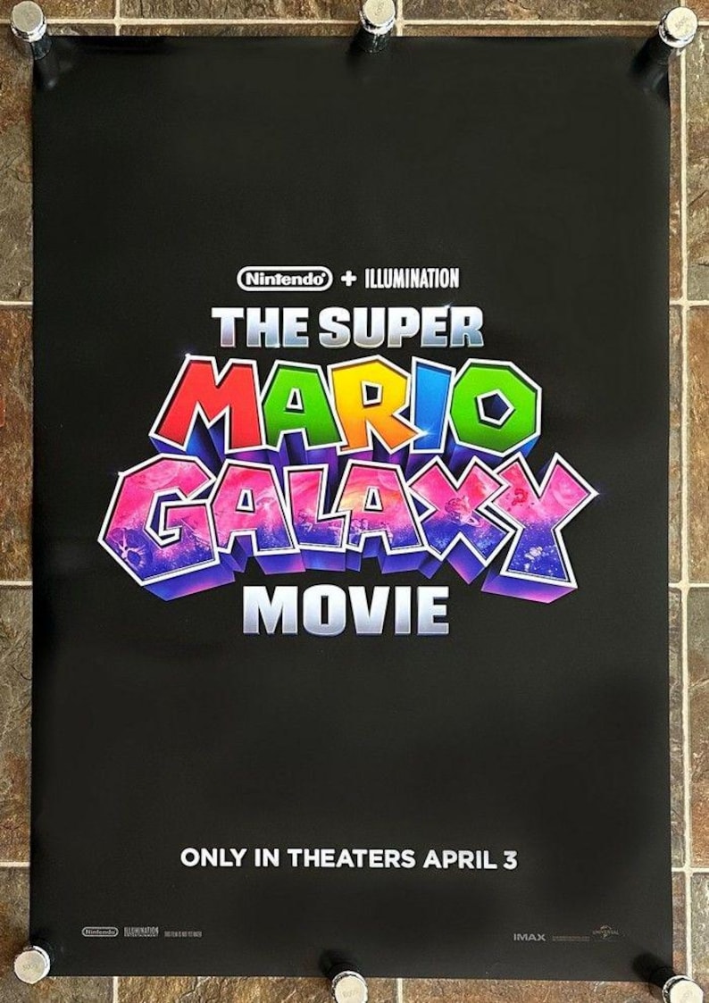 May include: A black movie poster for "The Super Mario Bros. Movie" with the Nintendo and Illumination logos at the top. The title is in colorful 3D lettering. The text "ONLY IN THEATERS APRIL 3" is at the bottom.