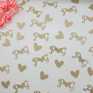 May include: Gold glitter confetti with hearts and the letters "P&G" for wedding or party decorations.