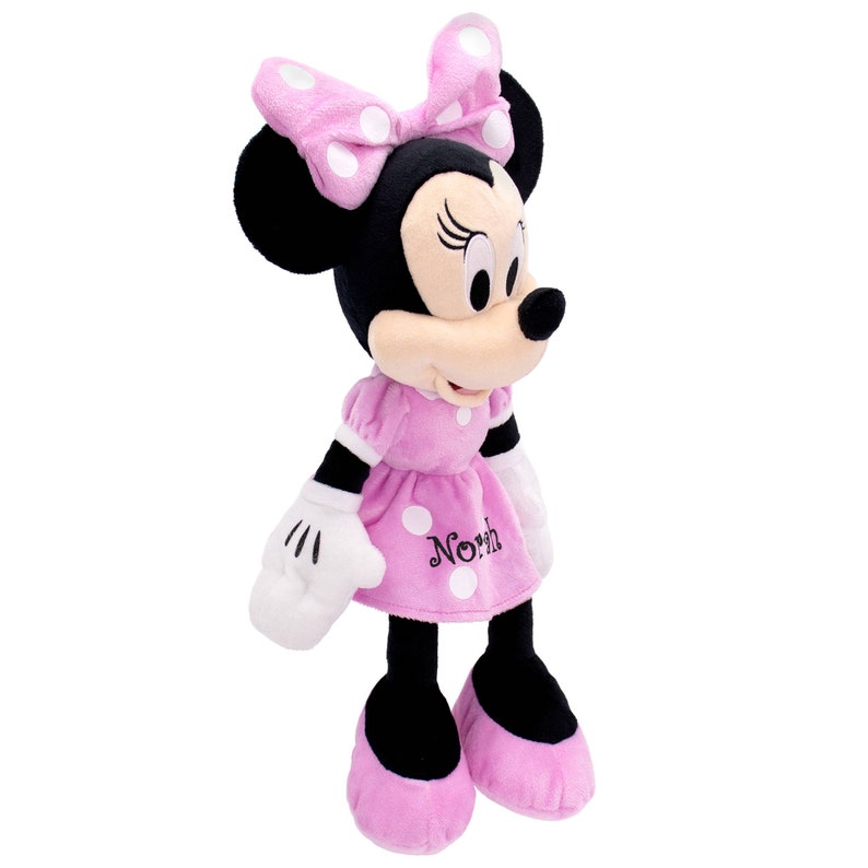 May include: Pink plush Minnie Mouse toy with black eyes, white polka dots on her dress and bow, and the word "North" embroidered on her dress.