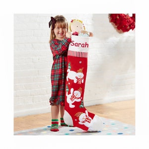 May include: A red and white Christmas stocking with a snowman design. The stocking is personalized with the name "Sarah".