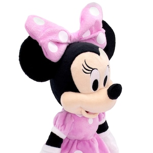 May include: A pink and black plush toy of Minnie Mouse wearing a pink bow with white polka dots and a pink dress with white polka dots.