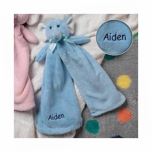 May include: Blue elephant baby security blanket with the name Aiden embroidered on it.