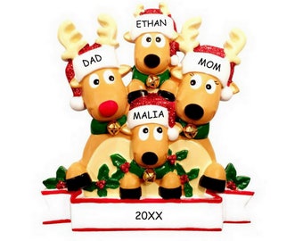 May include: A Christmas ornament featuring a family of four reindeer. The reindeer are stacked on top of each other, with the smallest reindeer at the bottom. The reindeer are wearing Santa hats with the names "Ethan", "Dad", "Mom", and "Malia" written on them. The ornament also has a banner with the year "20XX" written on it.