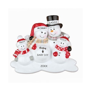 May include: A white snowman family Christmas ornament with red, white, and black accents. The ornament features a snowman couple with a baby snowman and a smaller snowman child. The snowman couple is labeled "Mommy" and "Daddy", the baby snowman is labeled "Baby Baby Ivy", and the smaller snowman child is labeled "Troy". The ornament also includes the text "20XX".